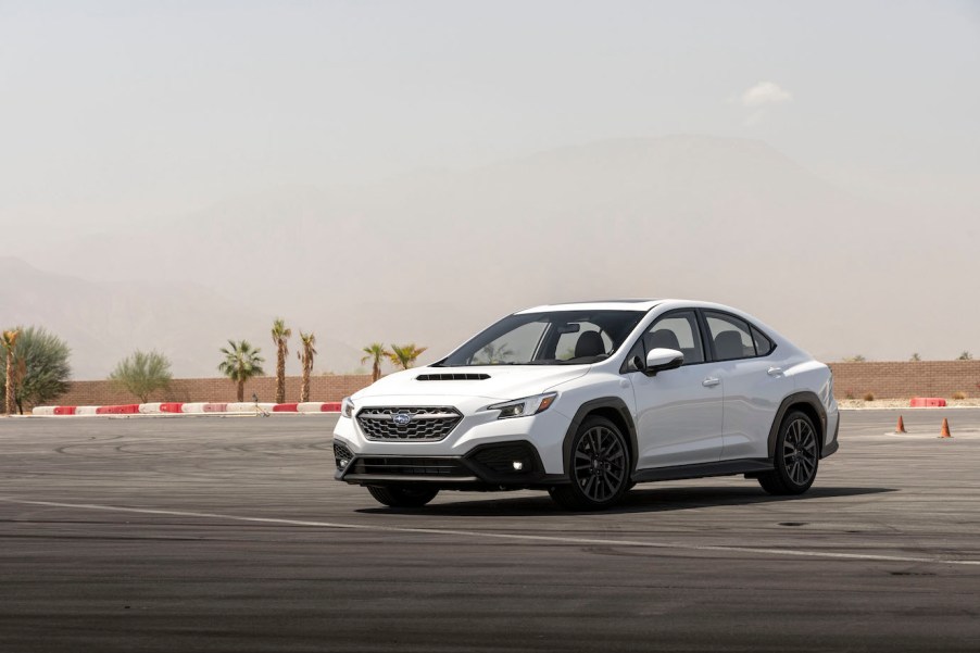 A white 2023 Subaru WRX parked on a track. Subaru sales across all major models are improved in 2023