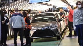 Workers assembling cars a Toyota factory.