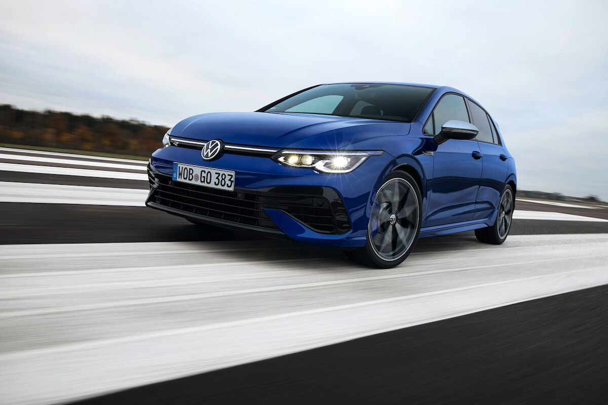 a Volkswagen Golf R driving down a road.