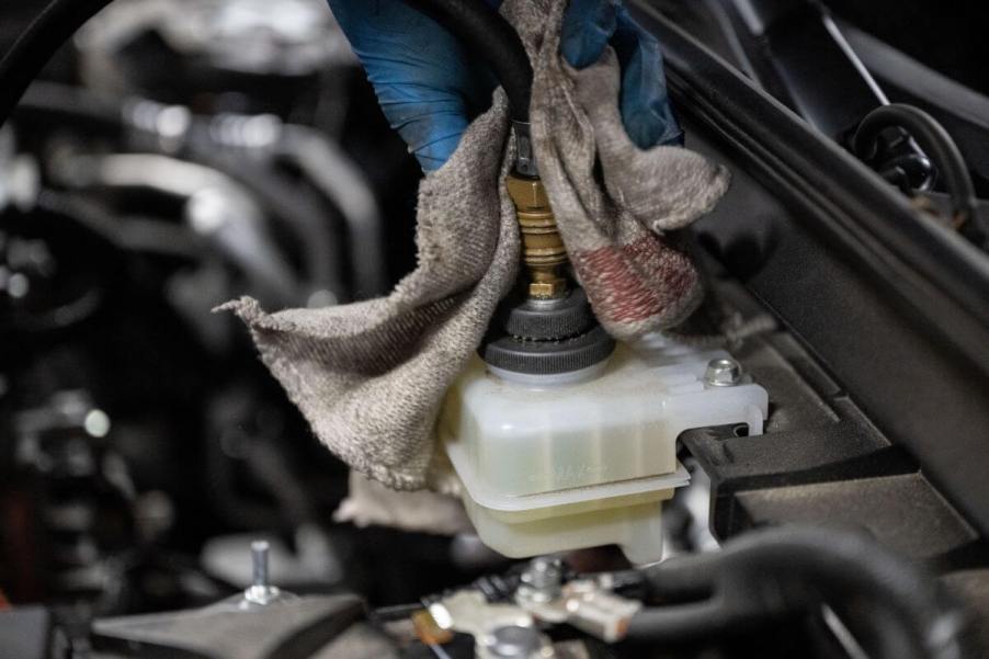 A brake fluid exchange and replacement on a Mazda MX-30 EV model in a auto shop garage