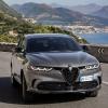 A 2024 Alfa Romeo Tonale plug-in hybrid compact SUV model driving on a scenic highway near seaside towns