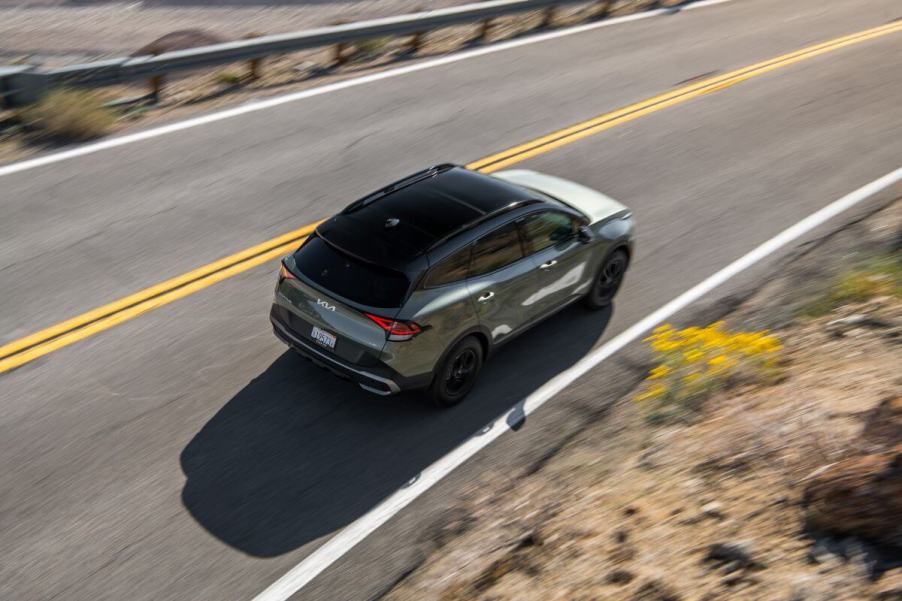 An overhead shot of a 2024 Kia Sportage X-Pro compact SUV model traversing a country highway