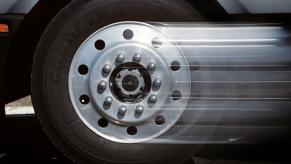 A closeup shot of a tire and hubcap on a pickup truck that begins to blur as it moves from acceleration