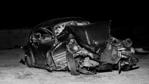 A crumpled motor vehicle involved in a car crash in the 1950s