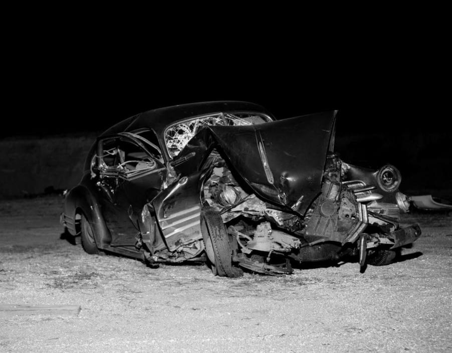 A crumpled motor vehicle involved in a car crash in the 1950s