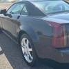 Closeup of the tail light in a black Cadillac XLR luxury sportscar coupe.