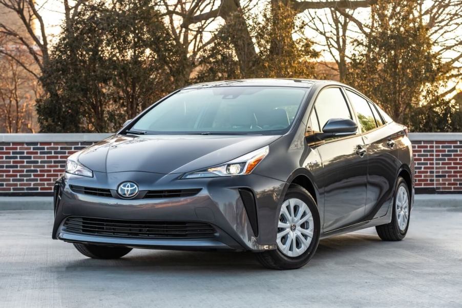 A used hybrid 2020 Toyota Prius L Eco shows off its hatchback car styling and front fascia.