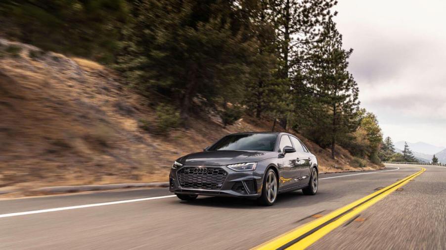 A 2024 Audi A4 compact executive car model on a forest highway road