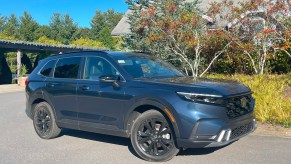 The 2023 Honda CR-V Hybrid parked near foliage