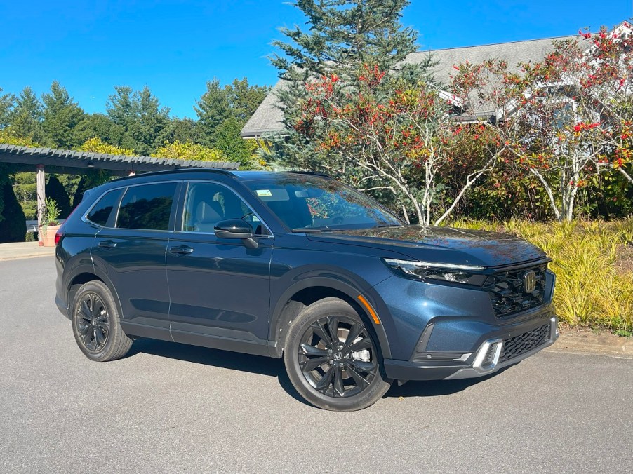 The 2023 Honda CR-V Hybrid parked near foliage