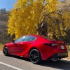 A rear corner view of the 2023 Lexus IS 500 on a canyon road