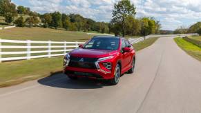 A red Mitsubishi Eclipse Cross driving down an open road.