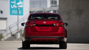 Red 2023 Nissan Versa rear shot. The Versa is the cheapest sedan in 2023.