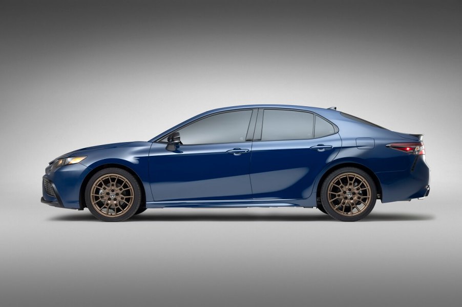 A blue 2023 Toyota Camry, the bestselling four-door car in America, shows off its midsize side profile.