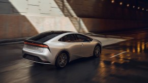 A silver 2023 Toyota Prius rear shot as it enters a tunnel. The Prius was the first model to be a popular hybrid before the new Toyota EV.