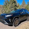 A front corner view of the 2023 Toyota RAV4 Woodland Edition on a mountain road