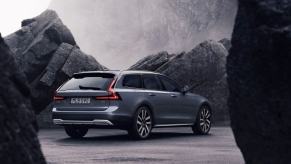 A exterior rear shot of a 2023 Volvo V90 Cross Country executive estate wagon model in Thunder Grey