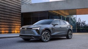 Gray 2024 Chevy Blazer EV parked in front of a modern building.