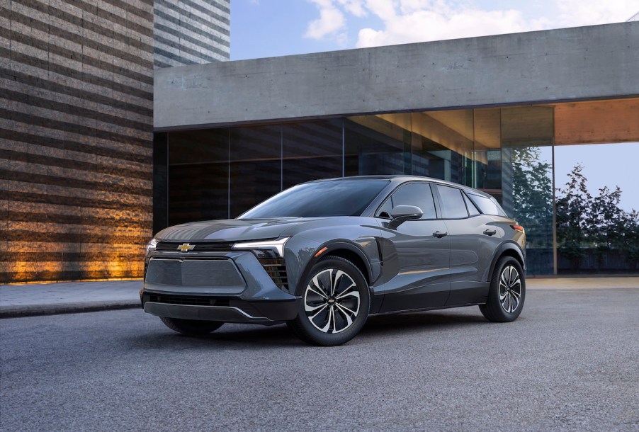 Gray 2024 Chevy Blazer EV parked in front of a modern building.