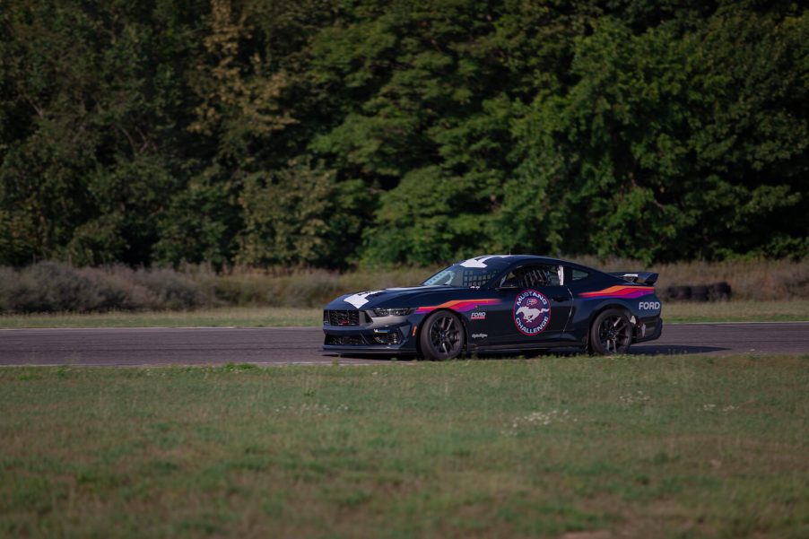 A black 2024 Ford Mustang Dark Horse on the track.