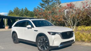 The 2024 Mazda CX-90 PHEV parked near foliage