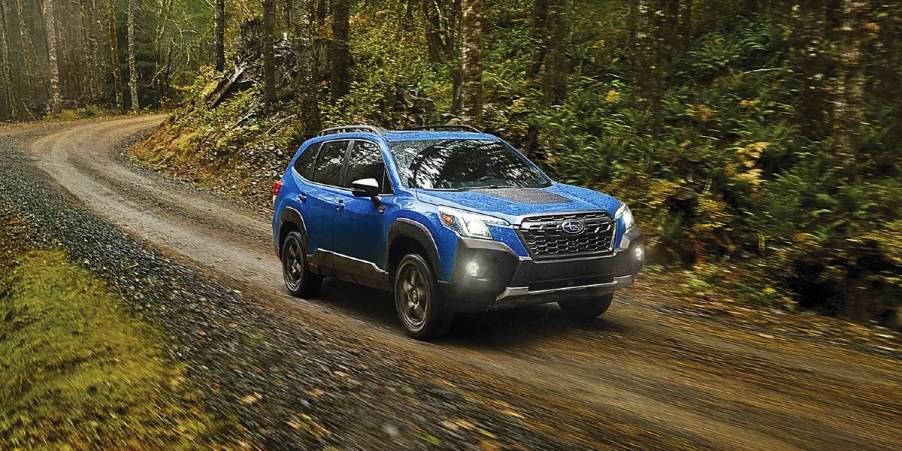 A blue 2024 Subaru Forester Wilderness is driving off-road.