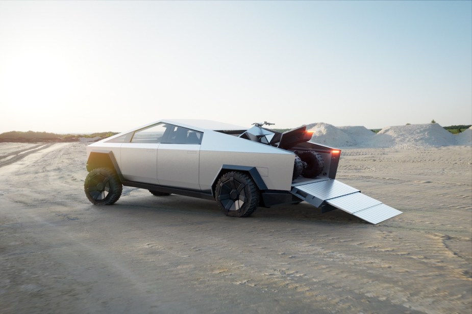 Cybertruck electric pickup with a Tesla quad in the bed.