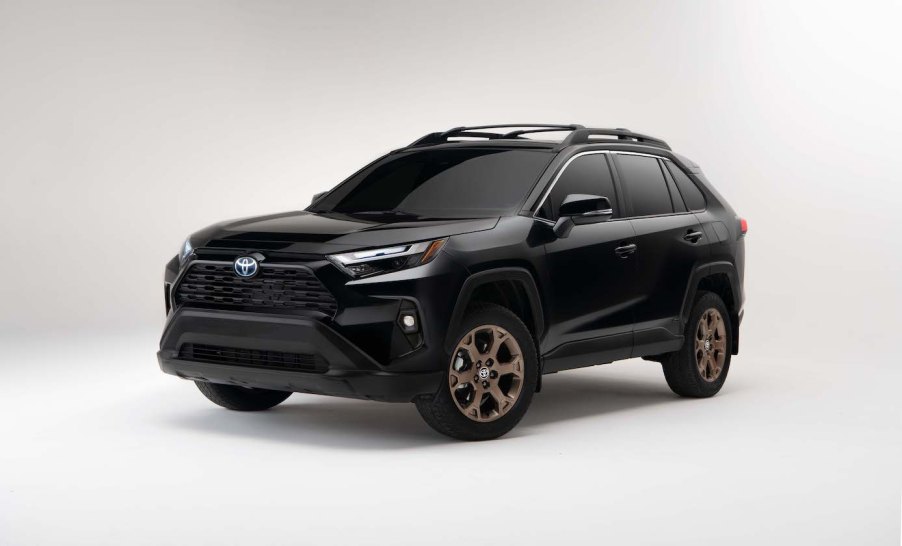 A black 2024 Toyota RAV4 Hybrid Woodland Edition against a white backdrop.