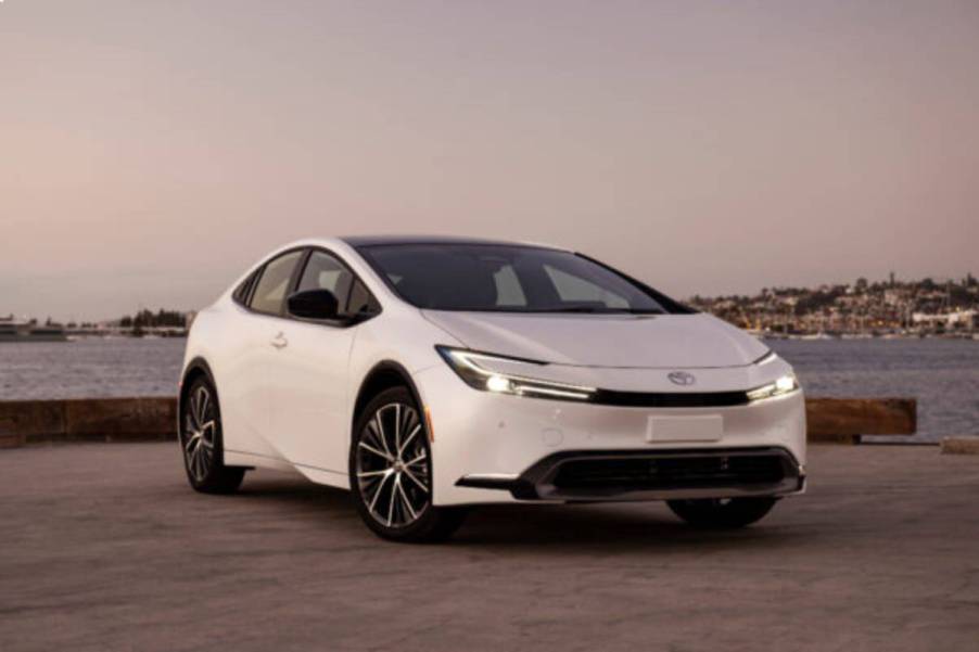 A white 2024 Toyota Prius on display outside.