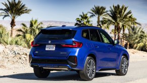 The cheapest BMW SUV, the BMW X1, pictured parked in blue on a sunny day.