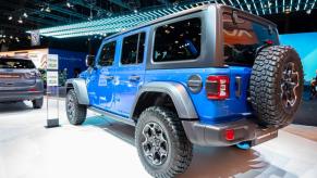 A blue Jeep Wrangler 4xe on display.