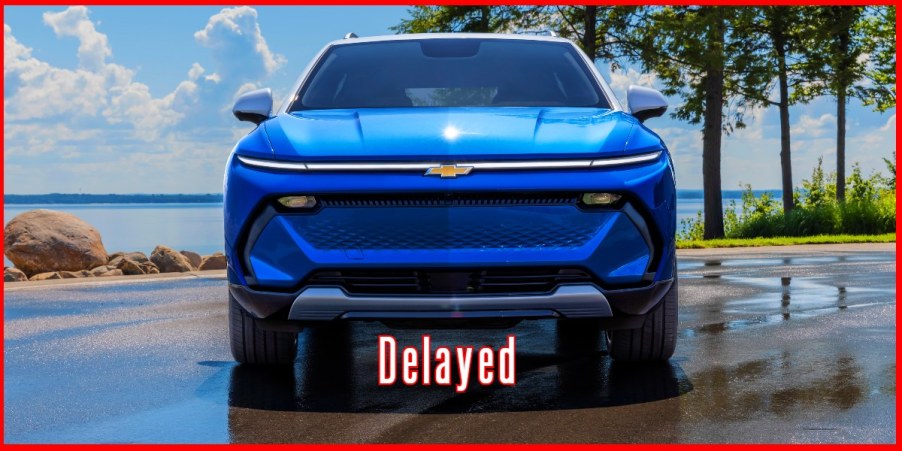 A blue 2024 Chevrolet Equinox midsize electric SUV is parked.