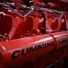 Closeup of the Cummins logo on a red diesel engine.