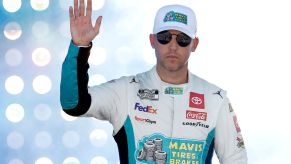 Denny Hamlin waves to fans.