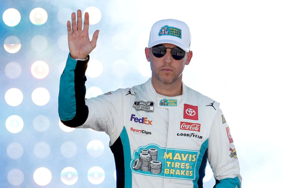 Denny Hamlin waves to fans.