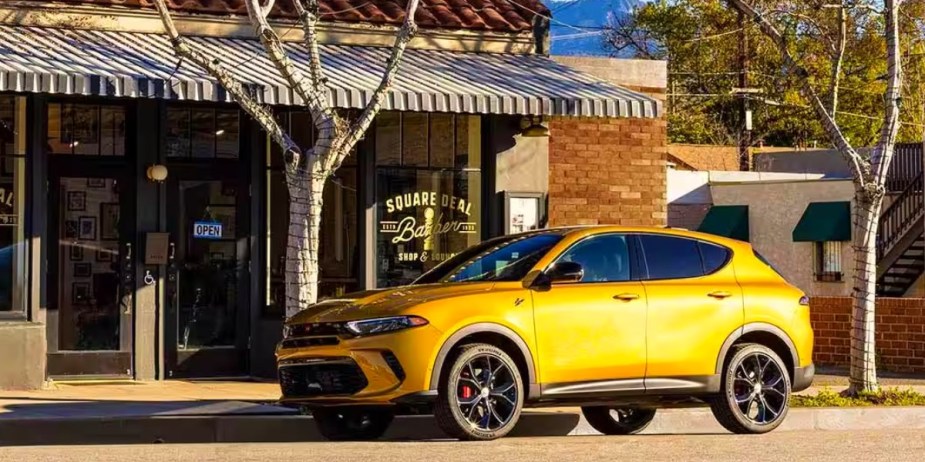 A yellow Dodge Hornet small SUV is parked. 