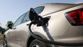 A tan/beige electric vehicle connected to a ultra-fast Pulse charger at a Gigahub in Birmingham, U.K.