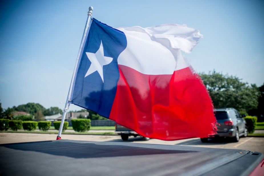 A flag mounted to the back of a truck 