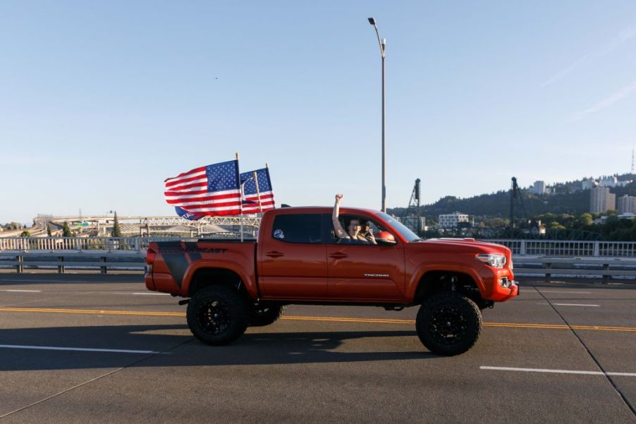 American flags flying on a pickup truck