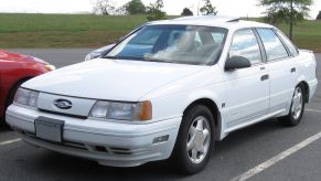 White Ford Taurus sedan SHO edition by SVT in a parking lot.