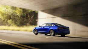 A blue Honda Accord driving underneath an overpass. A fully loaded 2024 Honda Accord isn't in luxury territory.