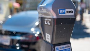 A lone San Francisco parking meter with car in background