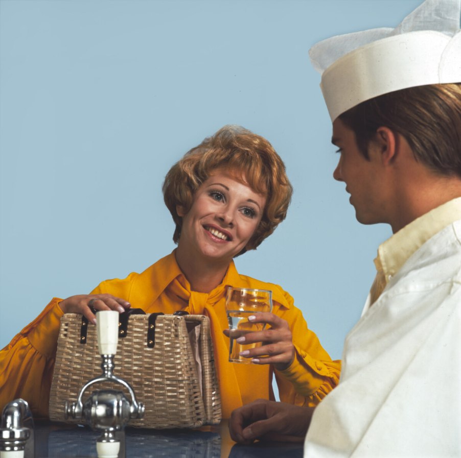 Lady smiling with soda jerk vintage image