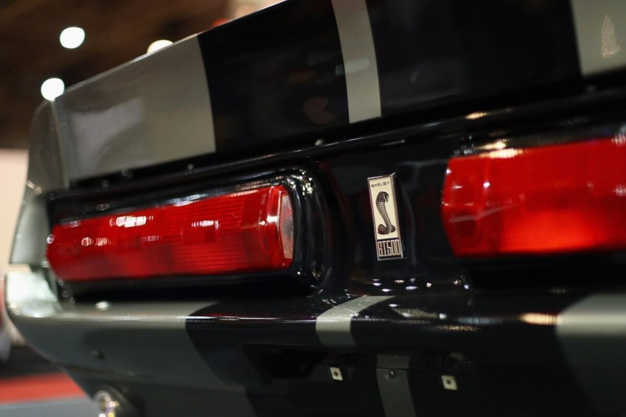 A gray and black Eleanor Mustang from Gone in 60 Seconds shows off its rear section at a car show.