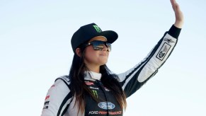 Hailie Deegan waves to fans.