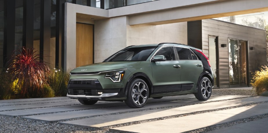 A green Kia Niro subcompact SUV is parked. 