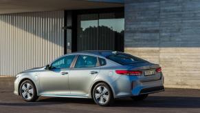 A rear shot of a silver Kia Optima Plug-in Hybrid. The Optima is the most dependable sedan in 2023.