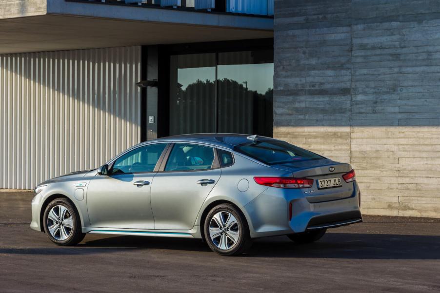 A rear shot of a silver Kia Optima Plug-in Hybrid. The Optima is the most dependable sedan in 2023.