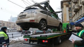 A Lexus SUV is getting towed.