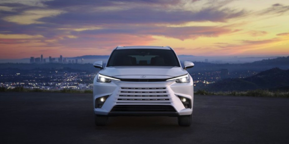 A white 2024 Lexus TX midsize three-row SUV is parked. 